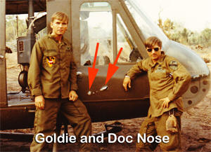 Goldie and Doc Nose look at combat damage to Medevac 2